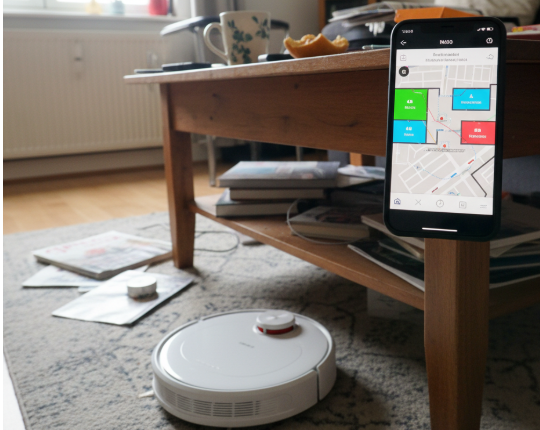 A smartphone showing a detailed and accurate map created by a robotic vacuum